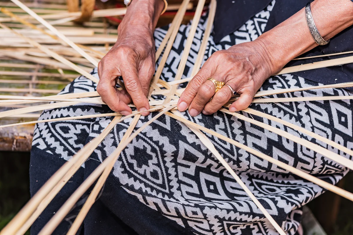 A women is crafting with bamboo